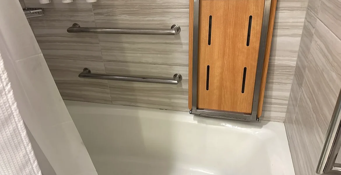 Accessible bathroom renovation detail with grab rails and practical bathing support