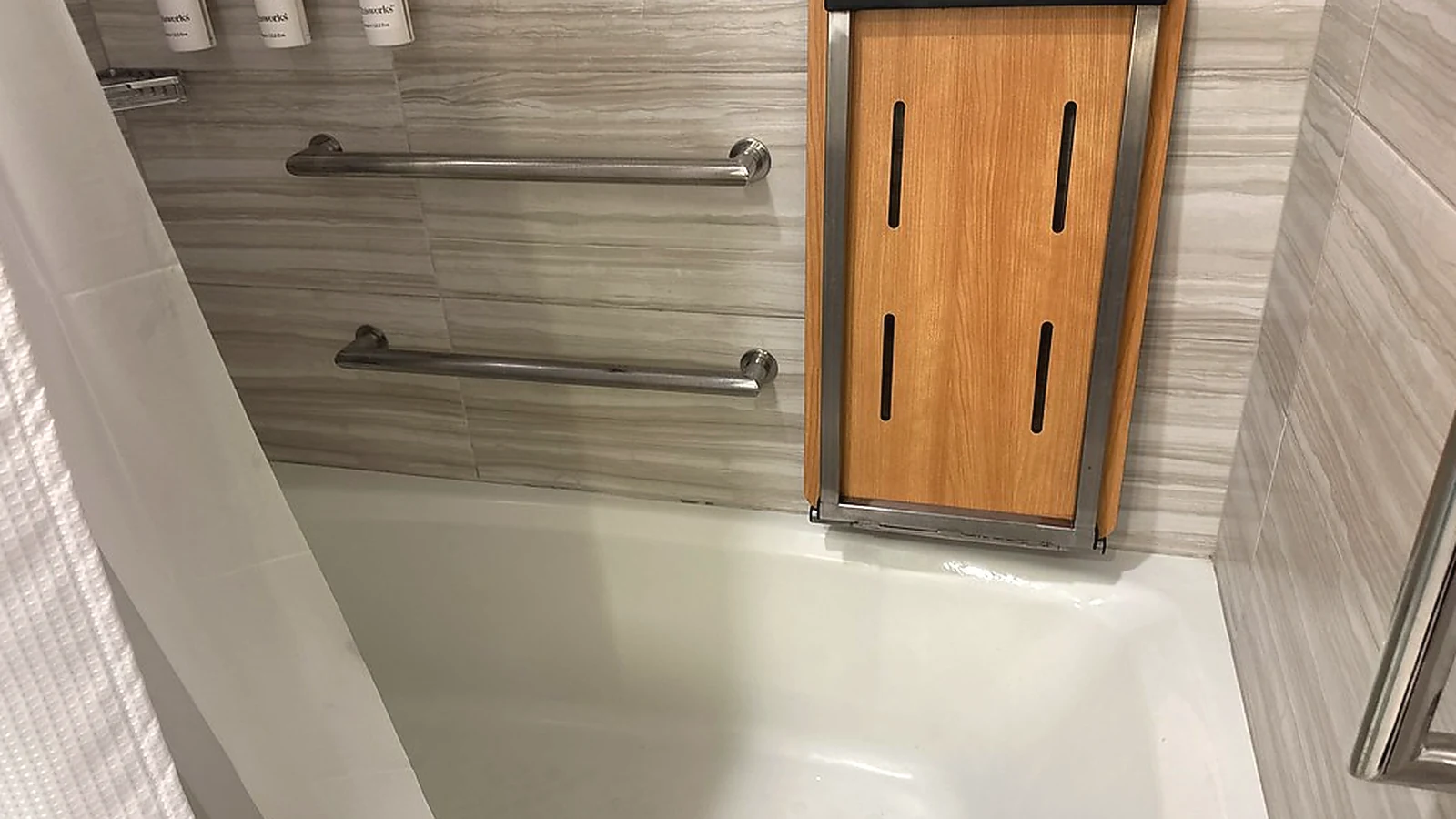 Accessible bathroom renovation detail with grab rails and practical bathing support