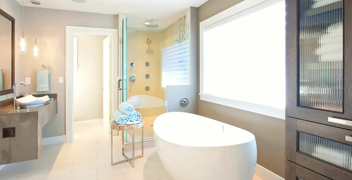 Bathroom layout with freestanding bath, vanity storage and walk-in shower area