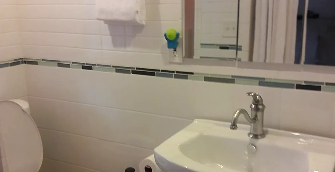 Bathroom storage ideas showing compact vanity unit, mirror cabinet and tidy basin area