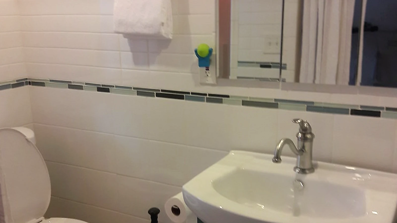 Bathroom storage ideas showing compact vanity unit, mirror cabinet and tidy basin area